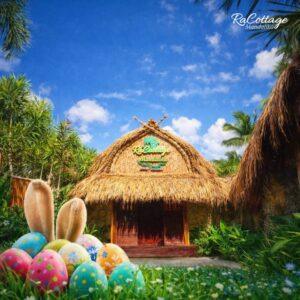 Easter Long Weekend in Lombok with colorful Easter eggs and bunny ears in front of a traditional thatched cottage at RaCottage Mandalika under a bright tropical sky