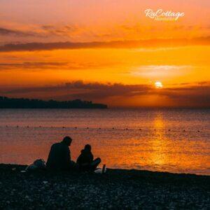 Couple enjoying a romantic sunset by the beach during a Lombok romantic adventure getaway near Mandalika