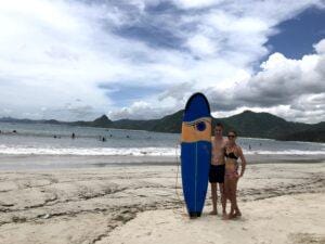 Surfing in Gerupuk Bay Lombok with surfers holding a board on the beach before a session