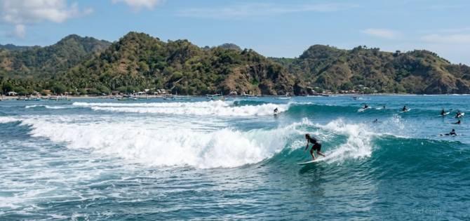 surfer enjot waves in gerupuk bay kuta lombok in july august