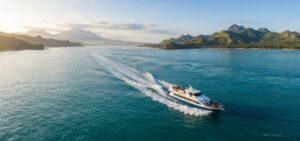 Bali to Lombok fast boat crossing turquoise strait with volcanic mountains and tropical coastline in background